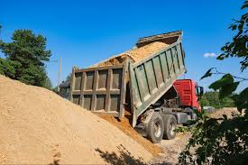 Dump truck unloading dirt at a jobsite